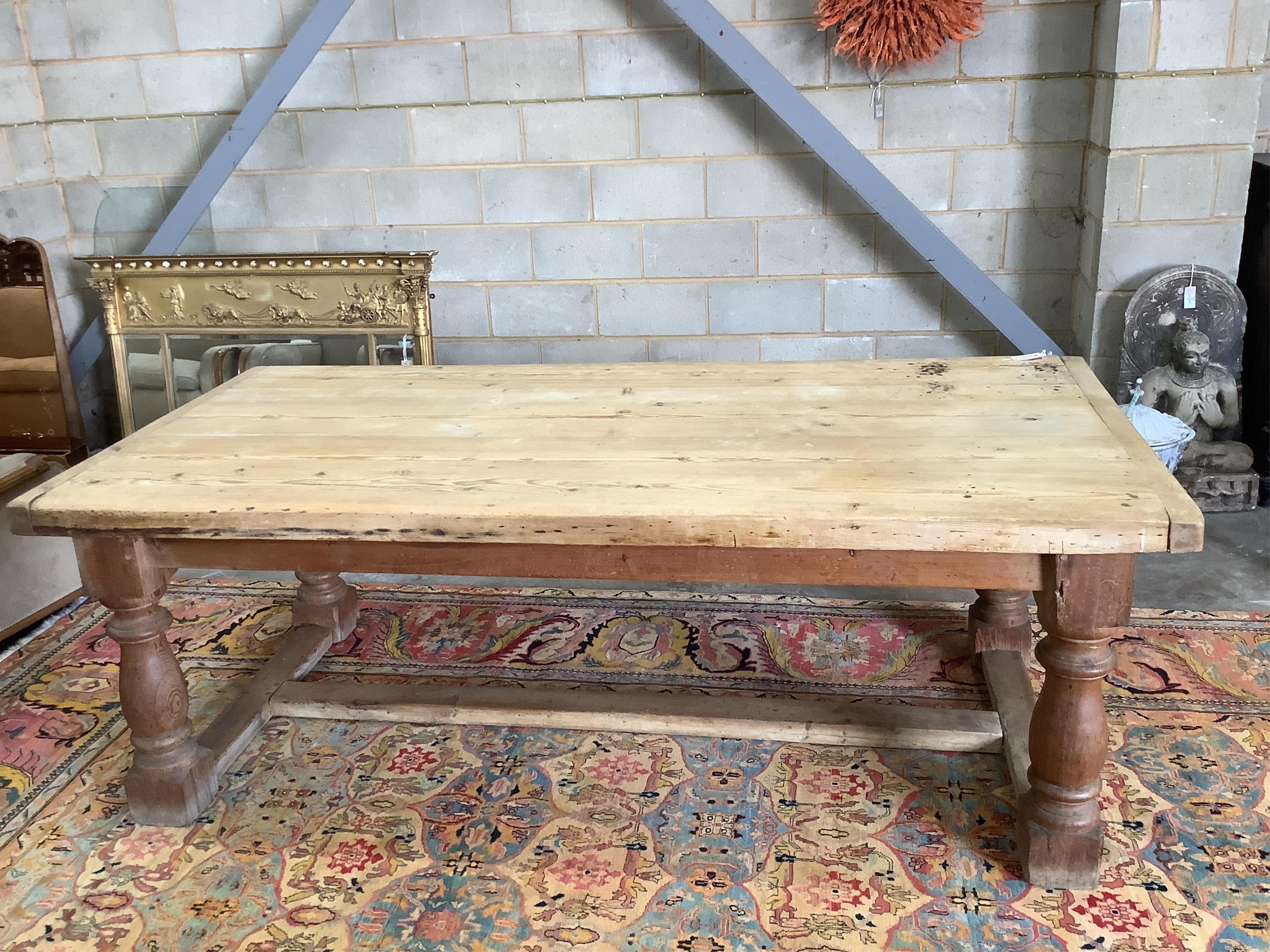 An 18th century style rectangular pine refectory dining table, width 220cm, depth 102cm, height 78cm. Condition - fair